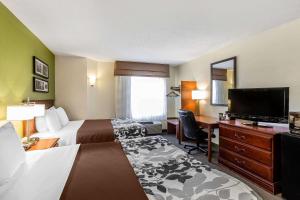 a hotel room with two beds and a flat screen tv at Sleep Inn Gaffney at I-85 in Gaffney