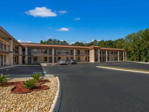 an empty parking lot in front of a hotel at Rodeway Inn in Greenwood