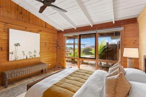 a bedroom with a bed and a large window at STUNNING PANORAMIC OCEAN VIEWS- A Perfect Getaway in Corinella