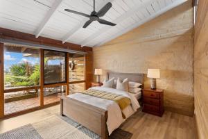 a bedroom with a bed and a ceiling fan at STUNNING PANORAMIC OCEAN VIEWS- A Perfect Getaway in Corinella