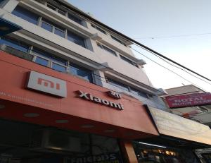 a building with a sign on the top of a store at Hotel Moon Star, Panipat in Pānīpat