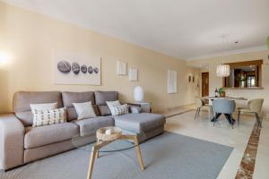 salon z kanapą i stołem w obiekcie Apartamento de 2 dormitorios en Bahía de Alcántara w Marbelli