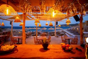 a restaurant with tables and chairs and lights at Aliv stone suites & spa in Agios Nikolaos
