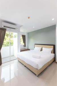 Postel nebo postele na pokoji v ubytování Green Hotel Phuket