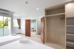Postel nebo postele na pokoji v ubytování Green Hotel Phuket