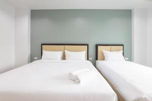 Postel nebo postele na pokoji v ubytování Green Hotel Phuket
