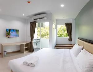 Postel nebo postele na pokoji v ubytování Green Hotel Phuket
