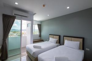 Postel nebo postele na pokoji v ubytování Green Hotel Phuket