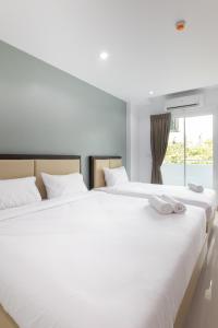 Postel nebo postele na pokoji v ubytování Green Hotel Phuket