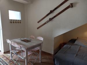 um quarto com uma mesa, cadeiras e uma cama em Sierra Nevada Apartment em Granada