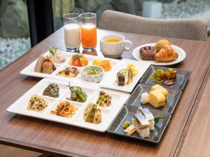 un plateau de nourriture sur une table avec des assiettes de nourriture dans l'établissement Hotel Keihan Kyoto Hachijoguchi, à Kyoto