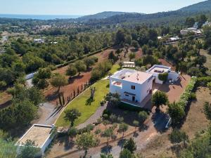 an aerial view of a white house on a hill at White House Ibiza Modernist Design Can Perez Sea views Es Figueral in Santa Eularia des Riu