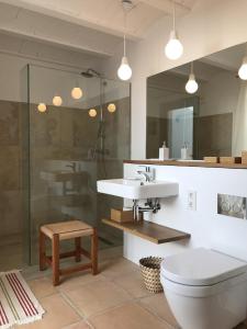 a bathroom with a toilet and a sink and a shower at White House Ibiza Modernist Design Can Perez Sea views Es Figueral in Santa Eularia des Riu