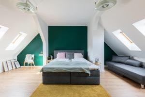 a bedroom with a bed and a green wall at Triple M Hotel in Budapest