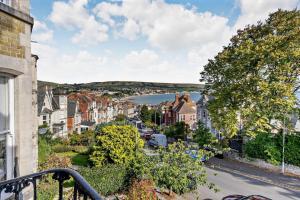 a view of a town with a river and houses at Dizzy Heights Swanage Sleeps 10 with Amazing Views in Swanage