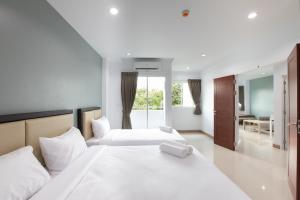 Postel nebo postele na pokoji v ubytování Green Hotel Phuket