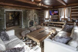 a living room with a wooden table and a fireplace at Chalet Joseph Mine in Josefuv dul