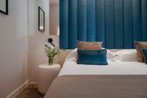 a bedroom with a bed with a blue curtain at Hotel Lungomare in Riccione