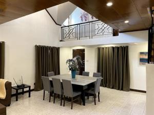 a dining room with a table and chairs at Charming 3-Bedroom Country Farm Home Pool ParkSprings Lipa in Lipa