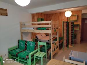 a room with two bunk beds and a chair at AH Xamedu Sal Hostel in Santa Maria