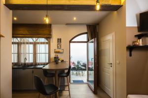 a kitchen and dining room with a table and chairs at Apáca 30 Apartman **** Győr in Győr +45 photos