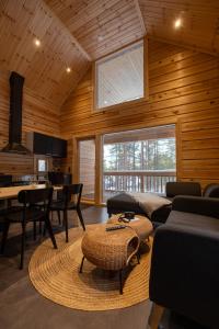 a living room with a couch and a table at Black Work Levi Aihki in Kittilä