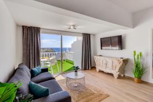 a living room with a couch and a table at Sea sand and sun in Callao Salvaje