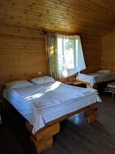 a bedroom with two beds in a log cabin at Old Halidzor in Halidzor