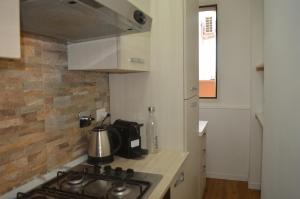 a kitchen with a stove and a counter top at Casa SoleLuna - alloggio turistico Rome Airport in Fiumicino