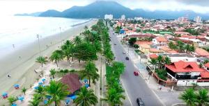 an aerial view of a city with a beach at Casa Peruibe. in Peruíbe