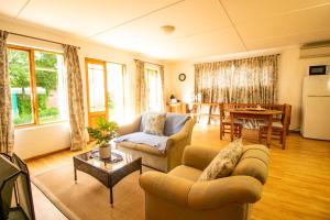 a living room with two couches and a table at Garden Cottage in Graaff-Reinet