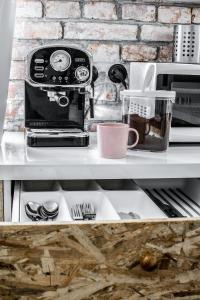 a coffee maker sitting on top of a shelf at LION apartments - Gold in Krakow