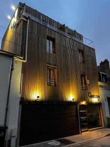 a large building with a gate on the side of it at 9WAGRAM Hotel Boutique in Le Mans