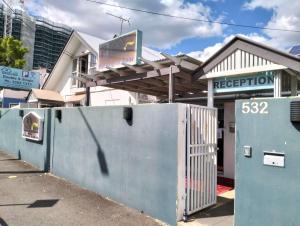 a building with a gate in front of a street at cliffinn kangaroo point in Brisbane