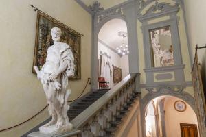 a statue of a man walking down a staircase at NH Collection Palazzo Gaddi in Florence