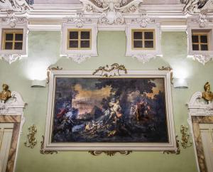 a large painting on the wall in a building at NH Collection Palazzo Gaddi in Florence
