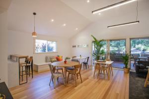 a kitchen and living room with a table and chairs at Sunny Side Up B&B Rye in Rye