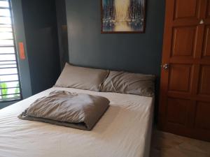 a bed with a pillow on it in a bedroom at REQUELstore in Sungai Pelik