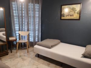 a room with two beds and a chair in it at REQUELstore in Sungai Pelik