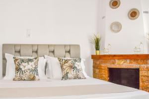 a bedroom with a bed and a fireplace at La Maison Plakes Rooftop Apt in Skiathos