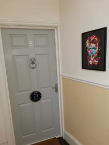 a door in a room with a painting on the wall at Upmarket 2 bedroom apartment with sea views in Torquay