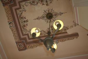 a chandelier hanging from a ceiling in a room at Archontiko Eleni Hotel in Andros