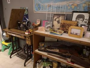 a room with a table with photos and a keyboard at REQUELstore in Sungai Pelik