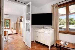 a living room with a flat screen tv on a wall at Villalaluna lacasa in Vejer de la Frontera