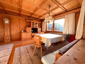 a dining room with a white table and a couch at Haus Barbara in Zell am Ziller