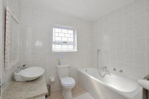a bathroom with a toilet and a tub and a sink at Yzerview in Yzerfontein +24 photos