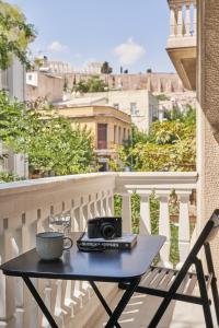 a table on a balcony with a camera on it at Sleeping with the Ancient Gods in Koukaki in Athens