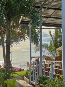 a porch with a white fence next to the beach at Lanta A&J Klong khong Beach in Ko Lanta