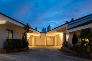 a house with two garage doors in a driveway at Motel Jardin in Oleiros