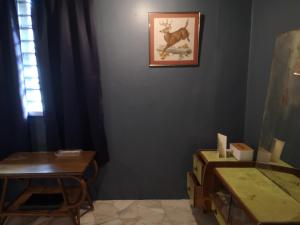 a room with a table and a picture on the wall at REQUELstore in Sungai Pelik